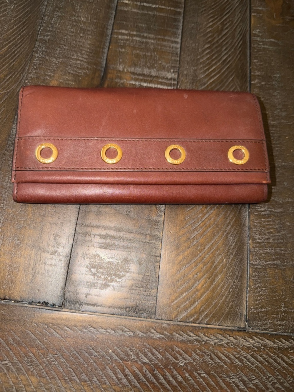 Tod's Brown Leather Continental Wallet with Gold Grommets